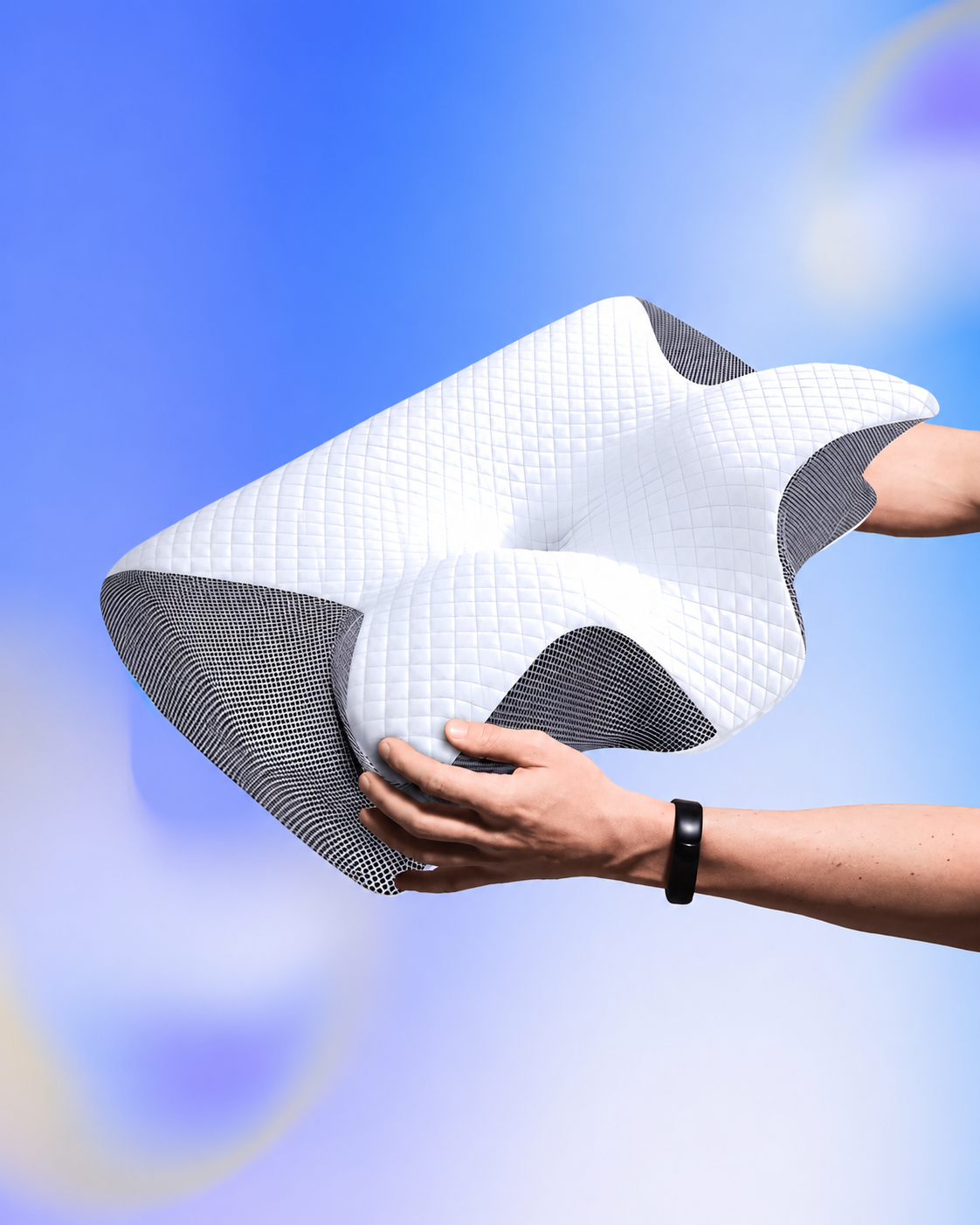Contour Comfort Pillow held in two hands against a blue support graphic